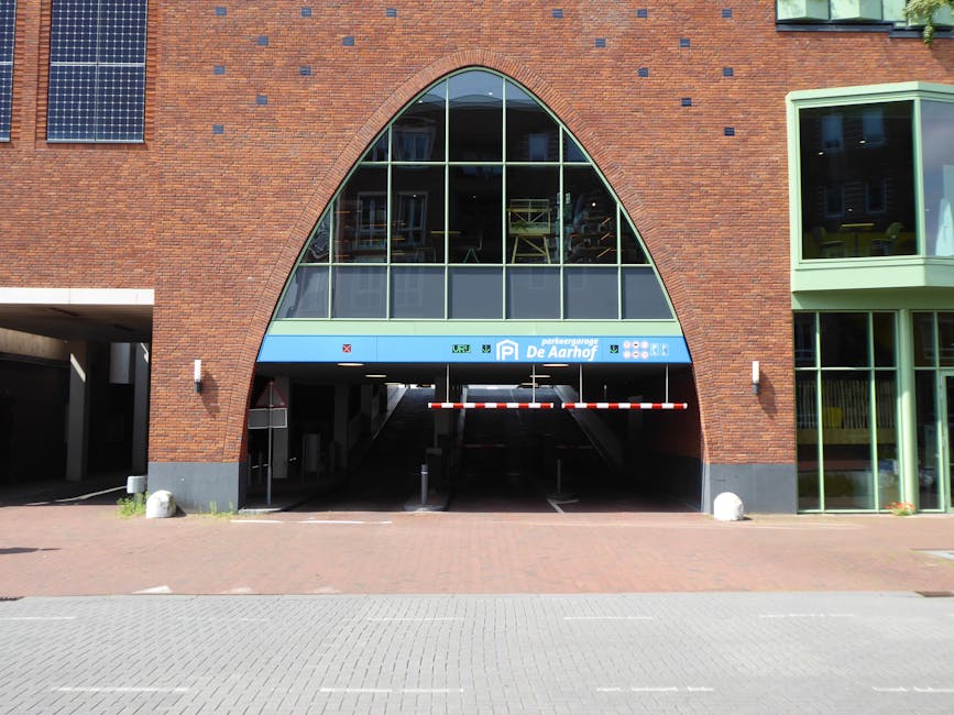 Entrance to a modern urban parking garage with a distinctive brick facade.